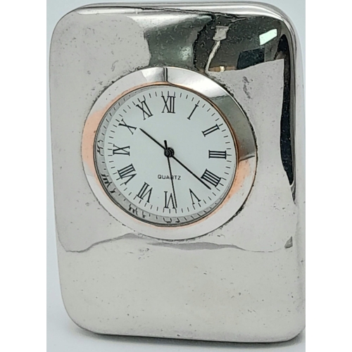 1307 - A Late 20 th Century Japanese, Modernist Design, Bi-Metal Quartz
Desk Clock/Paperweight. 7.5cm Tall.... 