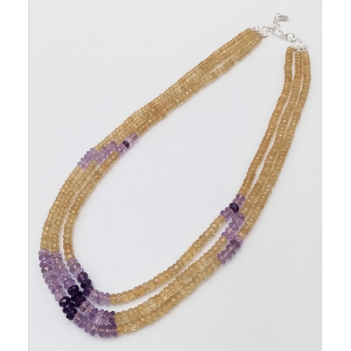 1428 - A beautiful three-row beaded necklace made up of citrine and amethyst gemstones, with a 925 silver c... 