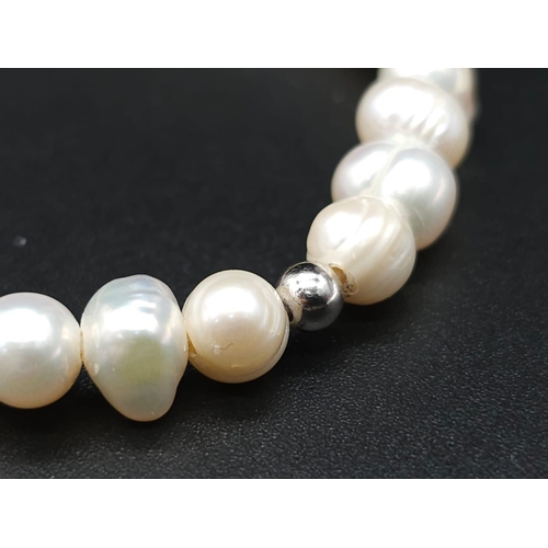 1706 - White Pearl Stretch Bracelet.
Measuring 6cm in diameter.