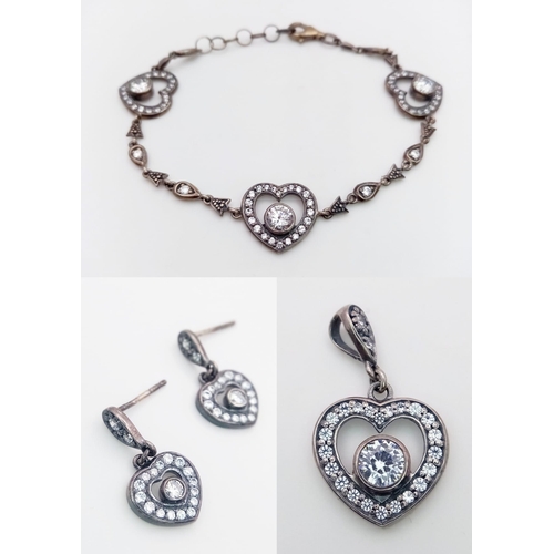 2001 - A set of 925 silver Cubic Zirconia heart jewellery include: a pair of earrings, a pendant and a link... 