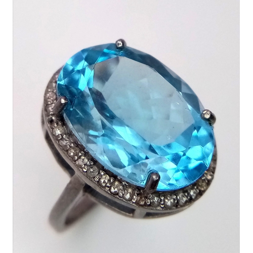 2889 - An Oval Blue Topaz Ring with Rose Cut Diamond Halo. Set in 925 silver. Topaz- 16.5ct, Diamonds - 0.3... 