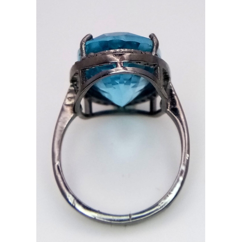 2889 - An Oval Blue Topaz Ring with Rose Cut Diamond Halo. Set in 925 silver. Topaz- 16.5ct, Diamonds - 0.3... 