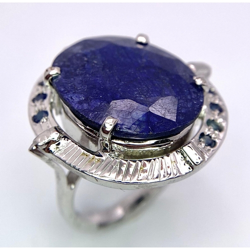 2893 - A Blue Sapphire and 925 Silver Ring. 13.90g. Size P. 14g total weight. Comes with a presentation cas... 