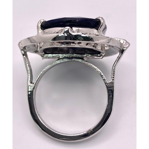 2893 - A Blue Sapphire and 925 Silver Ring. 13.90g. Size P. 14g total weight. Comes with a presentation cas... 