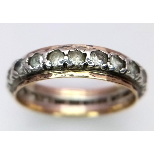 2890 - A 9K Gold and Silver White Stone Eternity Ring. Size J. 1.80g total weight.