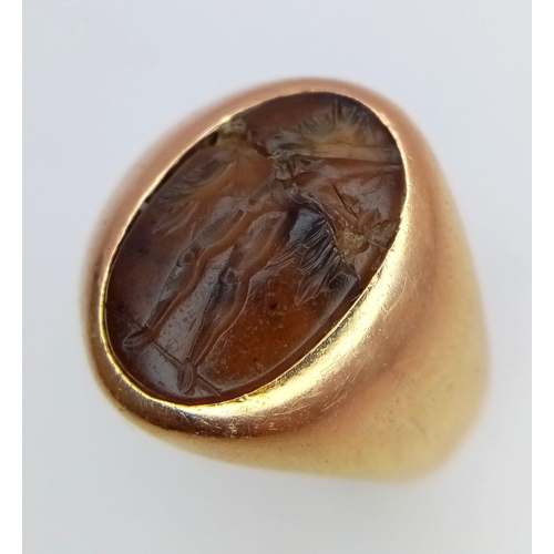 1150 - A Vintage 18K Yellow Gold Carnelian Signet Ring. A carved central stone of what appears to be an ima... 