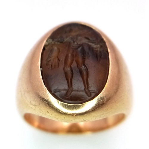 1150 - A Vintage 18K Yellow Gold Carnelian Signet Ring. A carved central stone of what appears to be an ima... 