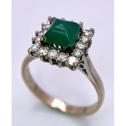 1613 - A Vintage 1975 (hallmarked) 18K White Gold, Diamond and Emerald Ring. A central square step-cut emer... 