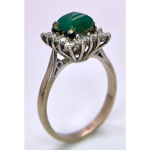 1613 - A Vintage 1975 (hallmarked) 18K White Gold, Diamond and Emerald Ring. A central square step-cut emer... 