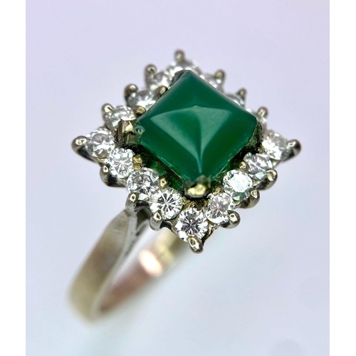 1613 - A Vintage 1975 (hallmarked) 18K White Gold, Diamond and Emerald Ring. A central square step-cut emer... 