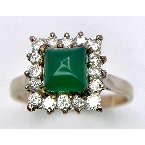 1613 - A Vintage 1975 (hallmarked) 18K White Gold, Diamond and Emerald Ring. A central square step-cut emer... 