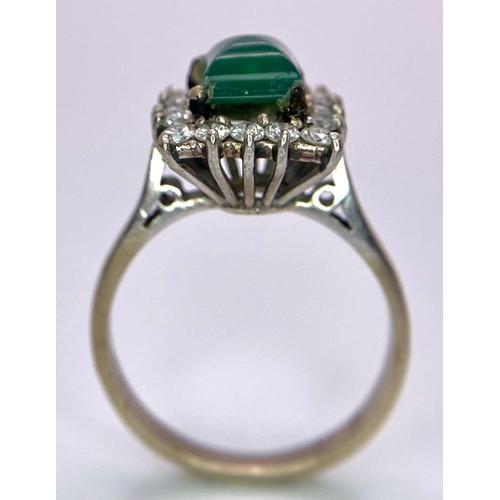 1613 - A Vintage 1975 (hallmarked) 18K White Gold, Diamond and Emerald Ring. A central square step-cut emer... 