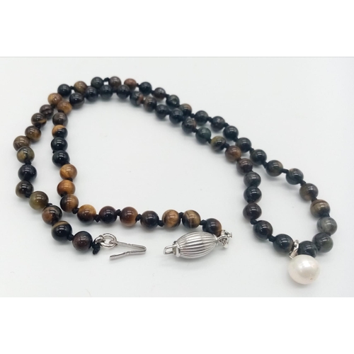 587 - A Tigers Eye Necklace with a Pearl Shell Pendant. 925 silver clasp and pendant. 1.5cm and 55cm, 28.2... 