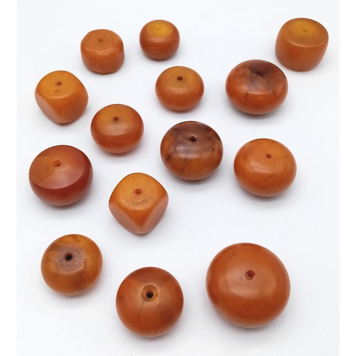 1116 - Collection of 14 Loose, Egg Yolk Amber Beads.
Various sizes and shapes, ranging from 2-4cm wide and ... 