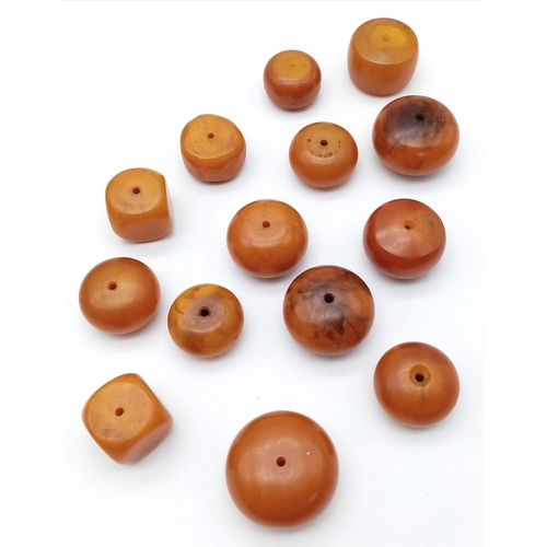 1116 - Collection of 14 Loose, Egg Yolk Amber Beads.
Various sizes and shapes, ranging from 2-4cm wide and ... 