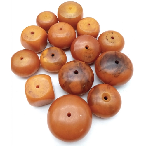 1116 - Collection of 14 Loose, Egg Yolk Amber Beads.
Various sizes and shapes, ranging from 2-4cm wide and ... 