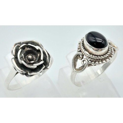 321 - A collection of Sterling Silver Rings.
One Flower Design, one Black Stone set.
Size: M (both)
Total ... 