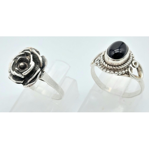 321 - A collection of Sterling Silver Rings.
One Flower Design, one Black Stone set.
Size: M (both)
Total ... 