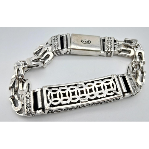 33 - A Tibetan silver double chained bracelet of Buddhist interest, with the “Vajra” symbol. Length: 21 c... 