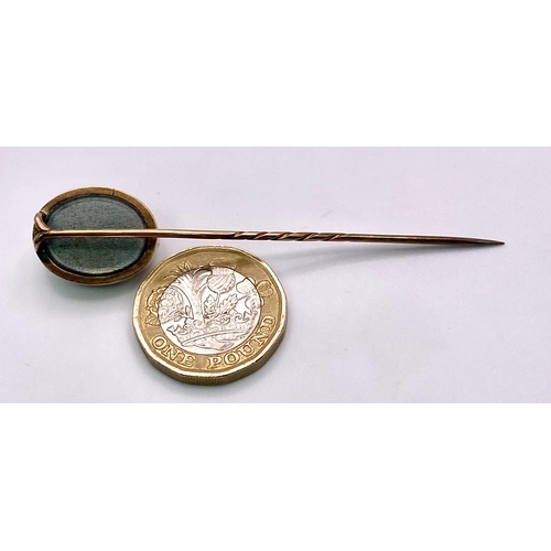 351 - An Antique Mid-Carat Gold Cameo Mourning Stick-Pin. 7.5cm.
4.67g total weight. Comes with original c... 