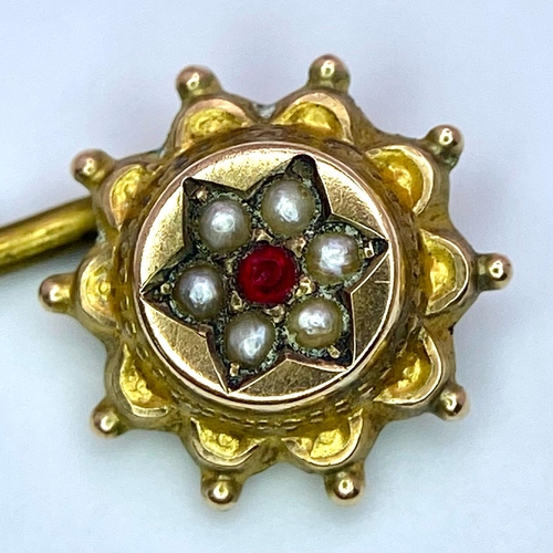 367 - An Antique Mid-Karat Gold, Seed Pearl and Ruby Stick-Pin. 5.5cm. 0.91g total weight.