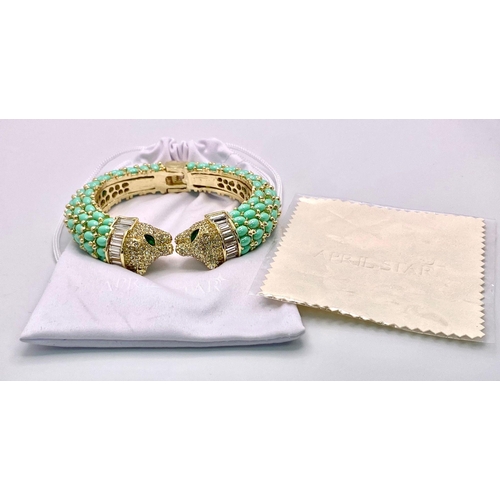 40 - An absolutely fabulous turquoise coloured bangle with cubic zirconia studded two panther heads, ador... 