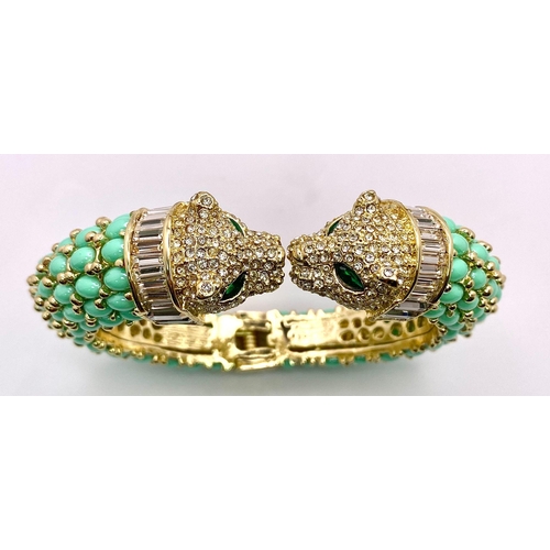 40 - An absolutely fabulous turquoise coloured bangle with cubic zirconia studded two panther heads, ador... 