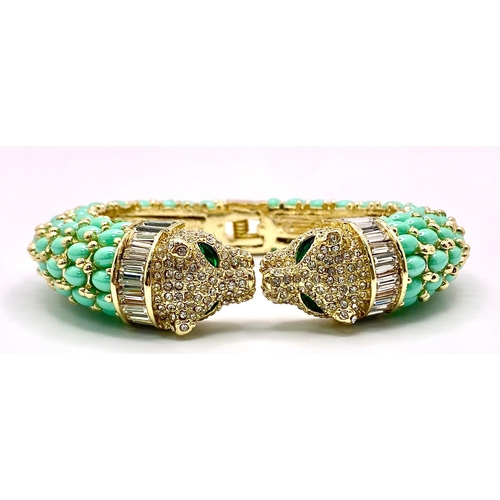 40 - An absolutely fabulous turquoise coloured bangle with cubic zirconia studded two panther heads, ador... 