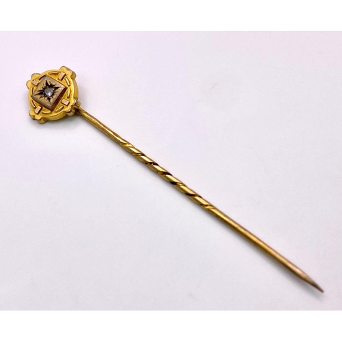 424 - An Antique Mid-Karat Gold and Diamond Stick-Pin. 6.5cm. Comes with its original French case. 1.52g t... 