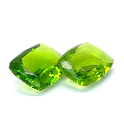 47 - A beautiful pair of large (16 carats each), emerald cut, PERIDOTS, with excellent colour uniformity ... 