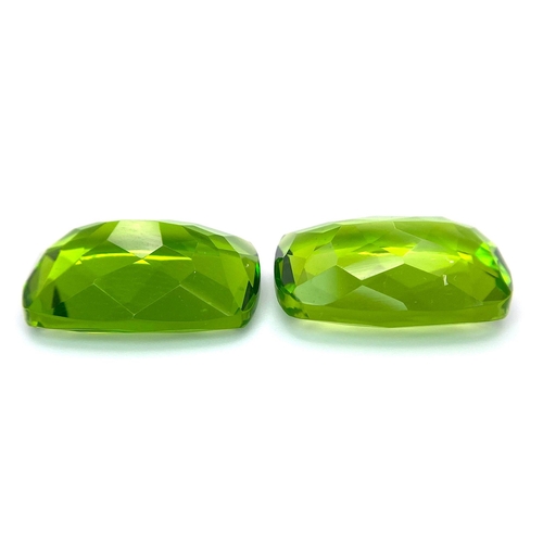 47 - A beautiful pair of large (16 carats each), emerald cut, PERIDOTS, with excellent colour uniformity ... 