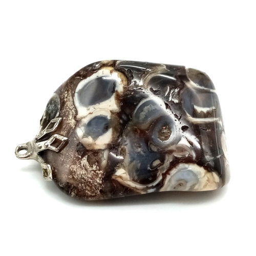 940 - Fascinating Marbleised Agate Pendant. 
Measures 3cm in lengths, filled with swirls of changing colou... 