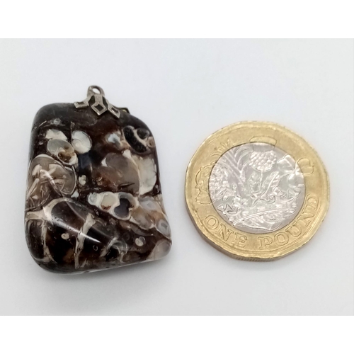 940 - Fascinating Marbleised Agate Pendant. 
Measures 3cm in lengths, filled with swirls of changing colou... 