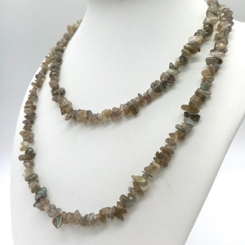 1135 - A parcel of Two Vintage Long Natural Stone Necklaces.
Both measure 90cm in length. The white necklac... 