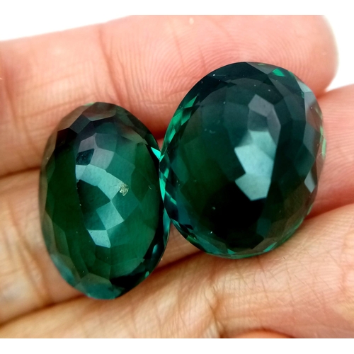 826 - Two Green Gemstones (40ct total). Possibly diopside. Oval cuts with trillion backs. No marks or incl... 