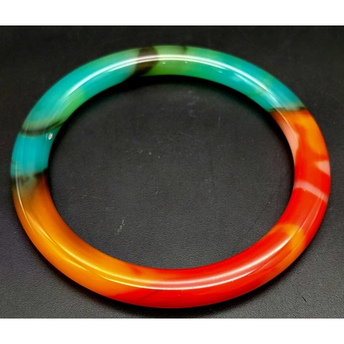 1124 - A Multi-Coloured Jade Bangle. 6cm inner diameter. 8mm width.