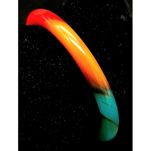 1124 - A Multi-Coloured Jade Bangle. 6cm inner diameter. 8mm width.