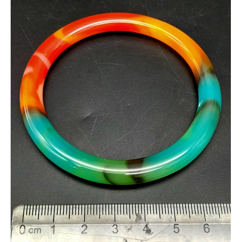 1124 - A Multi-Coloured Jade Bangle. 6cm inner diameter. 8mm width.