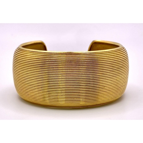 211 - A Theo Fennell Designer 18K Yellow Gold Fluted Cuff Bangle. 32mm width. 84.43g weight. Ref: 15247