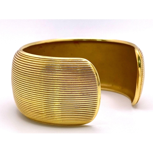 211 - A Theo Fennell Designer 18K Yellow Gold Fluted Cuff Bangle. 32mm width. 84.43g weight. Ref: 15247