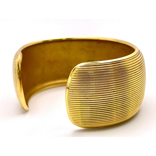 211 - A Theo Fennell Designer 18K Yellow Gold Fluted Cuff Bangle. 32mm width. 84.43g weight. Ref: 15247