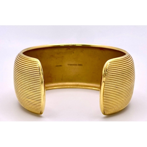 211 - A Theo Fennell Designer 18K Yellow Gold Fluted Cuff Bangle. 32mm width. 84.43g weight. Ref: 15247