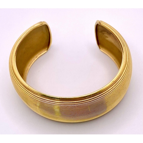 211 - A Theo Fennell Designer 18K Yellow Gold Fluted Cuff Bangle. 32mm width. 84.43g weight. Ref: 15247