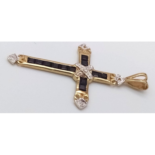 228 - A 9K YELLOW GOLD DIAMOND & SAPPHIRE CROSS PENDANT. TOTAL WEIGHT 1.1G ( 2 SMALL DIAMONDS MISSING HARD... 