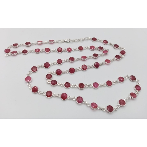 1104 - A Ruby Gemstone Matinee Length Necklace. Circle cut gemstones set in 925 Silver. 21.21g total weight... 