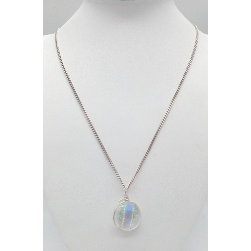 146 - A silver hologram pendant on 925 silver chain. Total weight 12.5G. Total length 68cm.