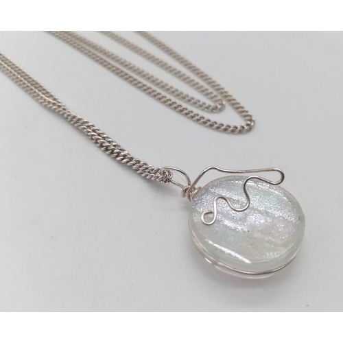 146 - A silver hologram pendant on 925 silver chain. Total weight 12.5G. Total length 68cm.