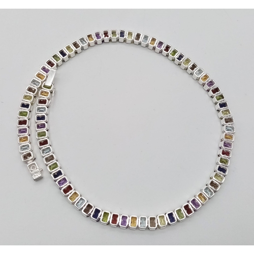 16 - A Kaleidoscopic Gemstone Tennis Necklace - Garnet, Amethyst, Blue Topaz and Smoky Quartz. Set in 925... 