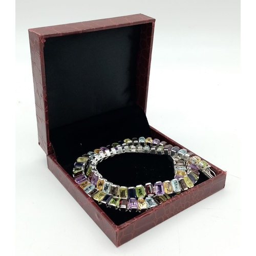 16 - A Kaleidoscopic Gemstone Tennis Necklace - Garnet, Amethyst, Blue Topaz and Smoky Quartz. Set in 925... 