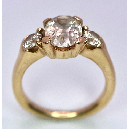 415 - An 18K Yellow Gold and Diamond Ring. 1.5ct oval cut central diamond with 0.15ct diamonds either side... 